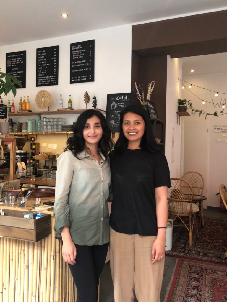 Two young women in a cafe. 