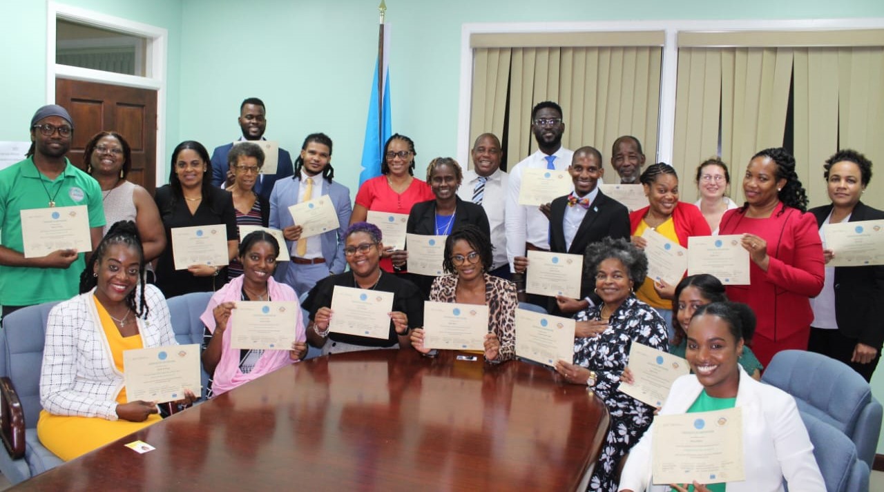 A group of people holding certificates and smiling at the camera.