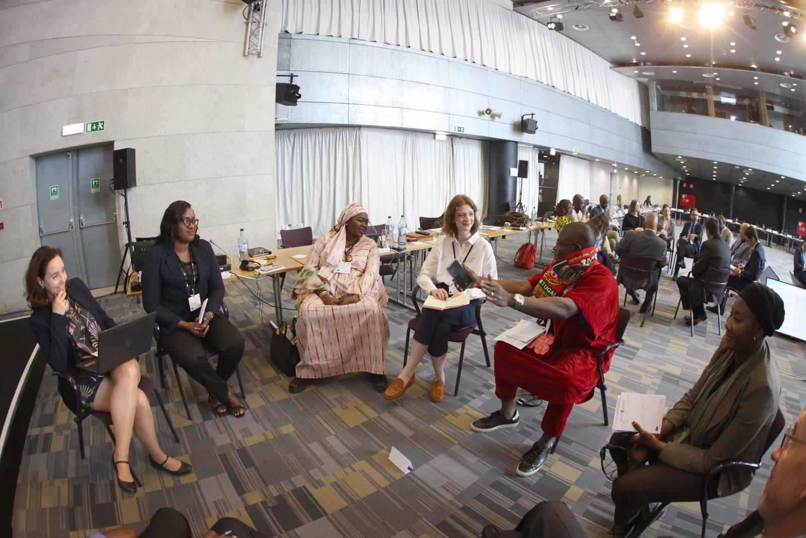 A group of people sitting in a circle having an animated discussion.